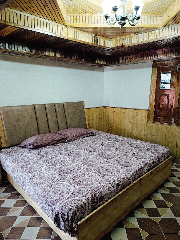 Deluxe mountain view room with wooden panelling at KinVatika Homestay