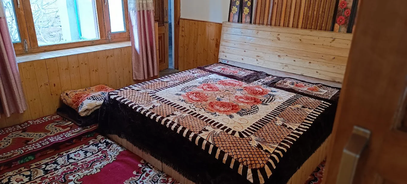 Family suite with large bed and traditional Kinnauri rugs